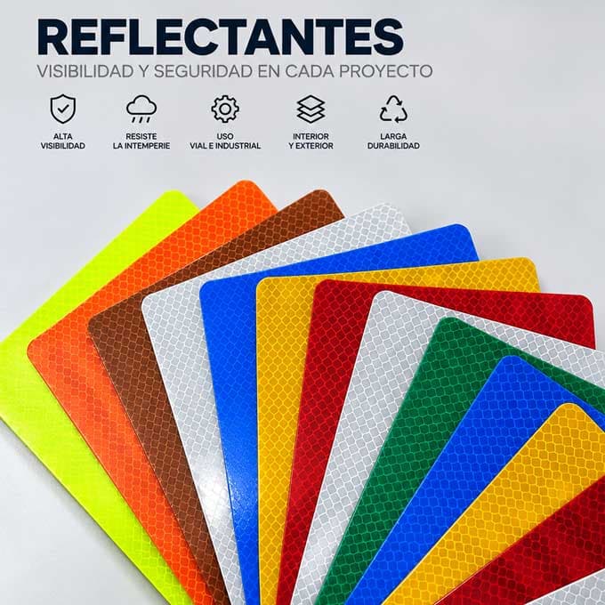 Abanico de láminas reflectantes desplegadas en amarillo fluorescente, naranja, café, blanco, azul, amarillo, rojo y verde, con el microprisma visible en la superficie